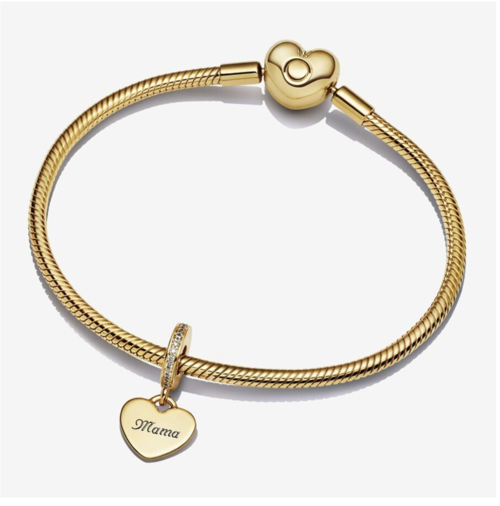 A gold-toned bracelet with a 'Mama' heart charm and a customizable tag, symbolizing a cherished and personal gift.